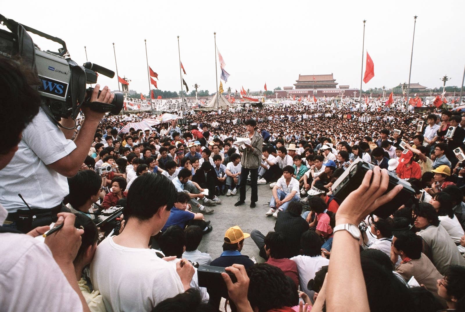 A pro-democracy movement leader talks into a microphone as he gives a press conference in Tiananmen Square.