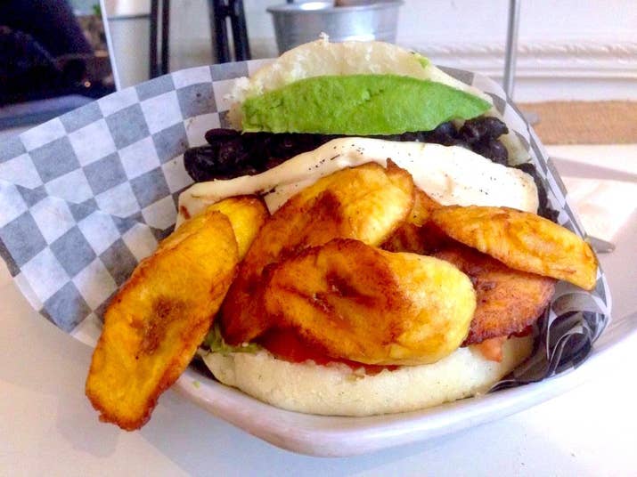 El Arepazo is a surprisingly large Kensington Market eatery, dedicated to the arepa. Arepas, a staple of Venezuelan and Columbian cuisine, are round, gluten-free cornbread sandwiches. Fried or baked, they are sliced crosswise like a pita bread and stuffed generously with all kinds of vegetables, salsas, beans, hot sauce, cheese, and meats. My arepa, called "Veggie The Works", was stuffed to the max with avocado, tomato, crispy fried plantains, melted queso fresco, and black beans. The fried plantains were my favourite part, and I noticed that the queso tasted like halloumi. I had to eat this sandwich with a fork because it wouldn't stay up, and as I neared the end of the sandwich, there was at least 1/4 of an avocado smashed in there. It was a fantastic sandwich made with truly fresh ingredients, but next time I will add a sprinkle of salt and some hot sauce.