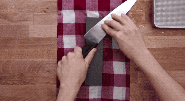 Or, use a whetstone to sharpen your knife. These come in a variety of "grits" (the higher the grit, the finer the stone) and must be soaked in water before using. To use them, give your knife a few strokes on the coarse side at a 20° angle, then do the same on the fine side.