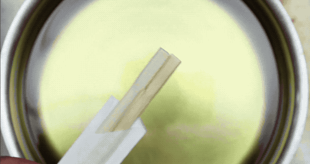 To check if your oil is hot enough for frying, submerge the end of a wooden chopstick in it. If the oil begins to bubble, it's at the perfect temperature for frying.