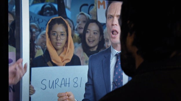 When Kevin sees Evie, the sign she's holding is a passage from the Quran.