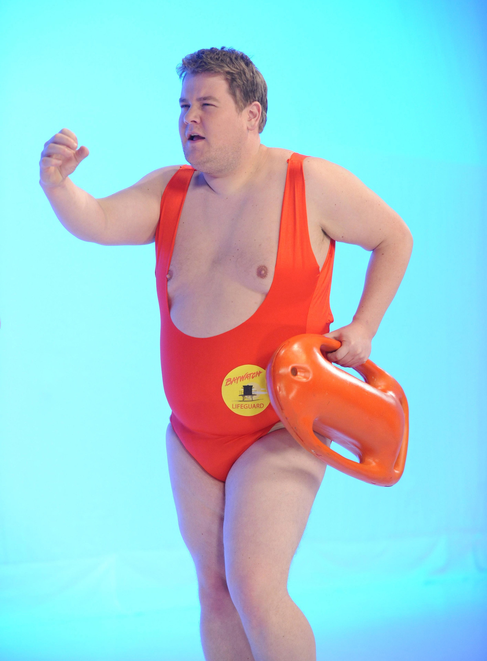 James Corden doing a photoshoot in a bathing suit. 