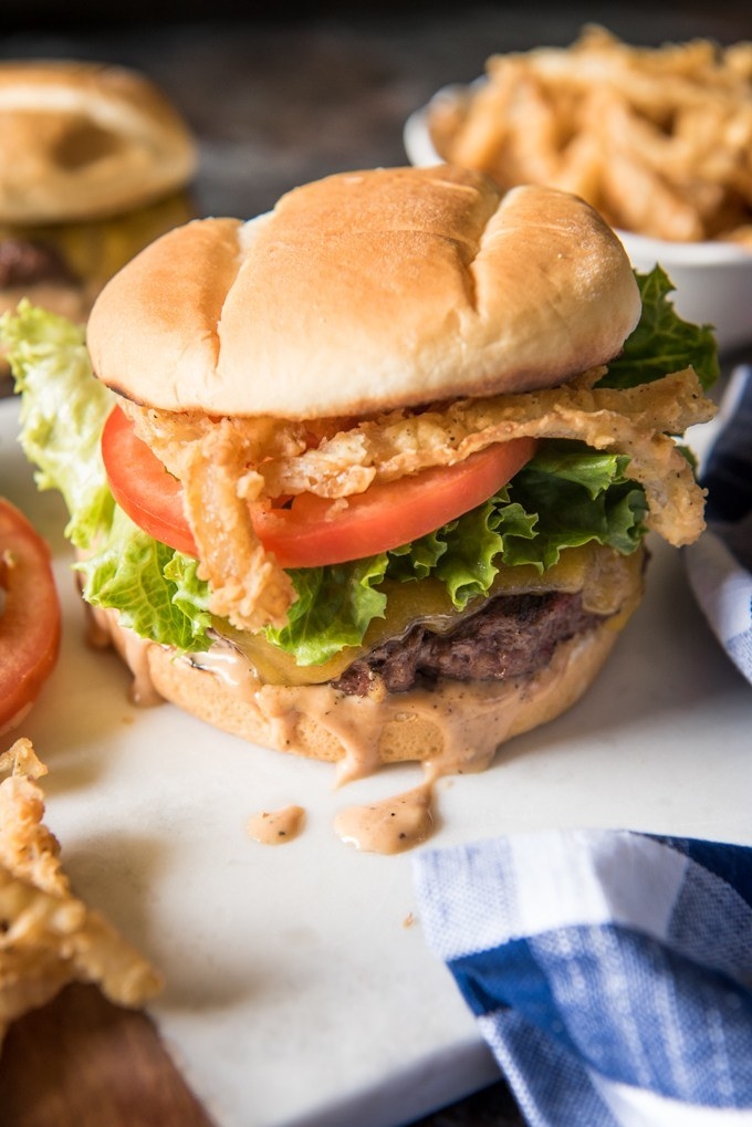 Kick off summer grilling season with this incredibly yummy all-American hamburger with crispy onion strings and burger sauce. Get the recipe here.