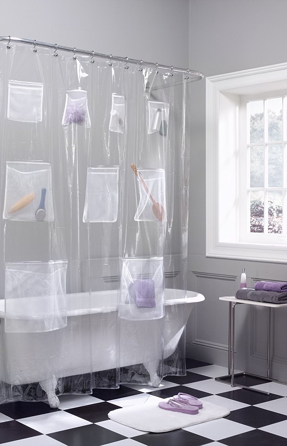 clear shower curtain with pockets holding bathroom accessories