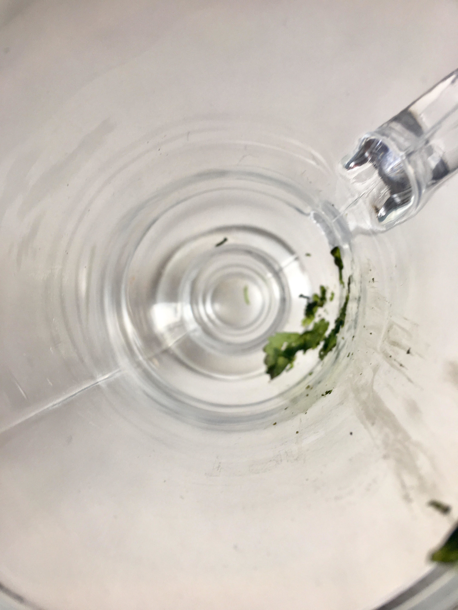 Take your mint leaves and muddle them in your glass with a spoon ‘till they’re PULVERIZED.