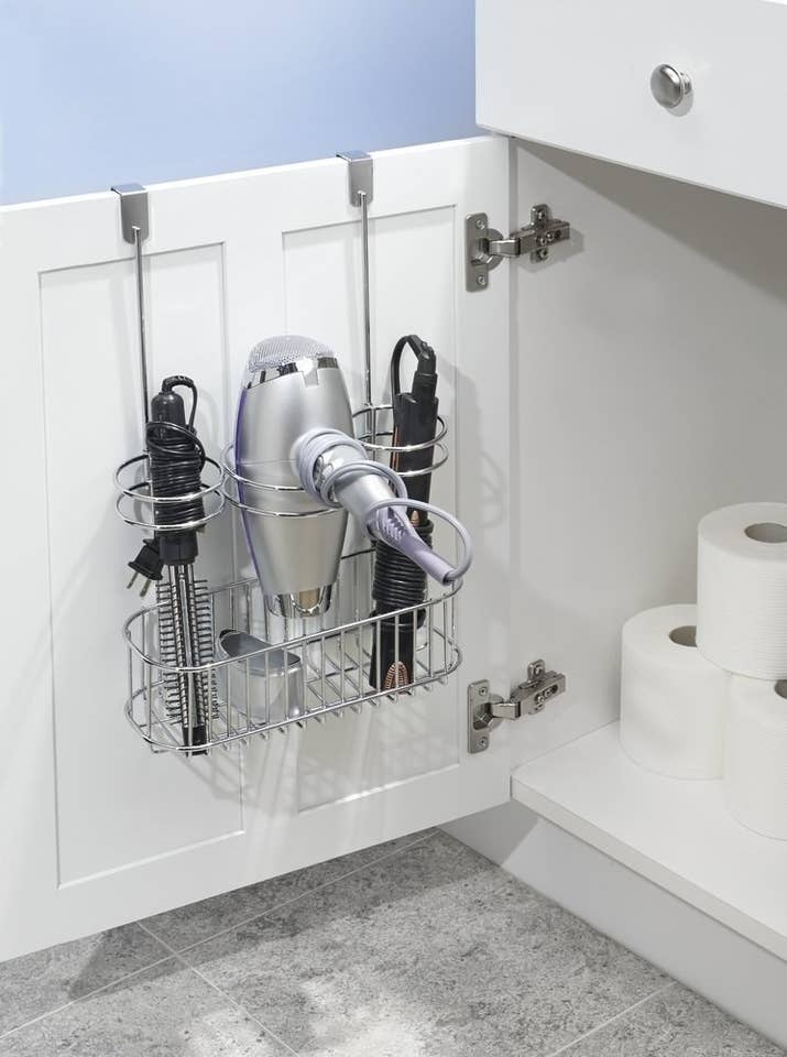 Get it from Amazon for $17.99.Promising review: "This is the most amazing invention EVER! Holds your straightener, blow dryer, curling iron or whatever else you want to store in the third slot. Now my stuff is all right there when I open the cabinet in my bathroom and the cords are not all tangled up!" —Abeau01