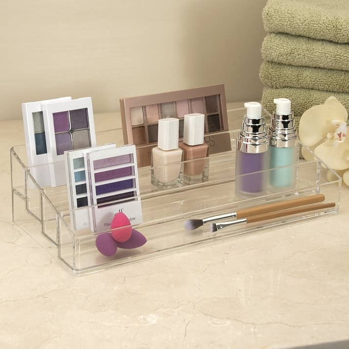 Get it from Amazon for $12.99.Promising review: "This is one of those things that so many of us need but hadn't come along for me until I was up late reading a BuzzFeed article on my phone. I am a MUA and have at least a dozen palettes currently in use, I keep them upright like books but it's not a flawless system. But with this! No more shifting anytime I take one palette out to use! No more of my cat pulling them down for fun because it's easy! I can even organize them by frequency of use! Fantastic, and totally worth the 13 bucks." —MP