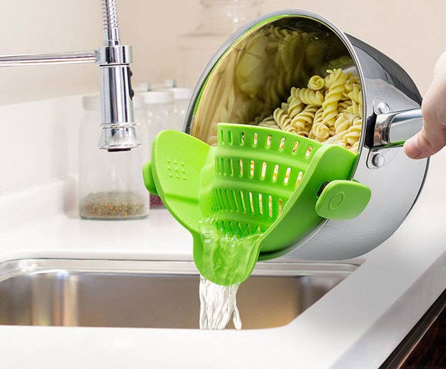 It's made of FDA-approved heat-resistant silicone, is dishwasher-safe, and fits on almost all pots.Promising Review: “This tool is so handy! There’s no food sliding over the edge of the pan and no steam hitting you in the face. It allows for perfectly drained pasta, meat, or whatever. It’s a great buy, and I'm glad I have it.” —MrsDGet it from Amazon for $12.99 (available in three colors).