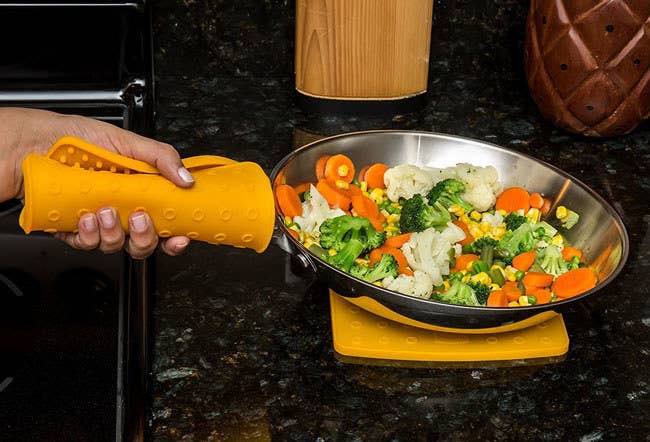 The trivets are made of FDA-approved silicone material won't stain, mold, mildew, or absorb odors. It's heat resistant up to 442 degrees.Promising Review: “I purchased these trivets to use with my new induction stove. I love them so much! They clean up very nicely in the dishwasher and are a great size. I purchased four of them so I could always have two on the counter to use as trivets. I use the other two for pot holders. The thickness is very adequate. I have not been burned using them as hot pads, and they are very flexible.” —QueenBGet a set of two from Amazon for $12.90 (available in eight colors).