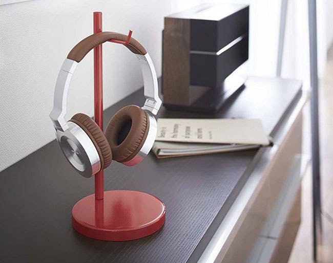 Promising Review: “This stand was easy to assemble. It has a stable bottom anchor weight with a relatively small desk footprint, which helps prevent tipping over. It is a really great buy, seeing that I did not want to mess up the finish on any of my furniture or wall to clamp, stick, hang, or drill in a headphone holder.” —Linda S.Get it from Amazon for $18 (available in three colors, with a round or square base).