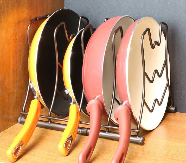 Get it from Amazon for $16.87.Promising review: "This holder is wonderful! It's very sturdy and strong, and all my pans except the wok fit beautifully into the rack. I actually no longer have pans falling all over themselves when I open my cabinet. I honestly do love it, and it was worth every penny." —Book Lover