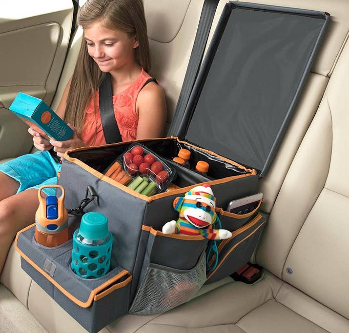 Besides the insulated compartments and outside storage pockets, it also adds two cup holders to your car, and you can flip down the lid for a tray table perfect for games.Get it from Amazon for $40.Promising review: "The shipping was slow but the bin is great! Can't be more happy about it. It holds everything and has numerous pockets or zipper bags to keep every small trinket organized. I ordered a large size and put it between two car seats in the middle row in an eight-seat minivan. It fits perfectly. The space divider in the large compartment is adjustable; you can place it anywhere you like. Cup holder is big enough to hold 21-oz. bottles which usually will not fit in a regular cup holder. I used to have a Diono car storage box. This one is much bigger and sturdier! Love it!" —Amazon Customer