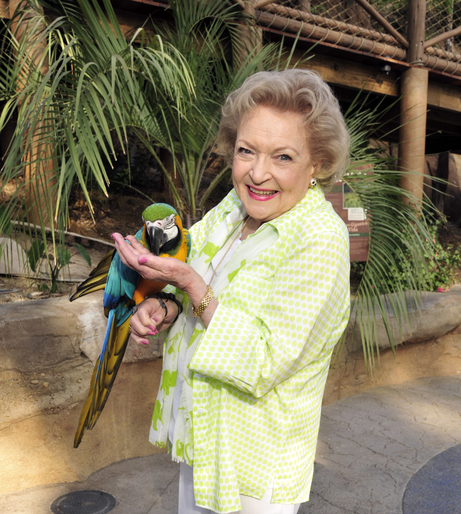 Smiling Betty holds a parrot