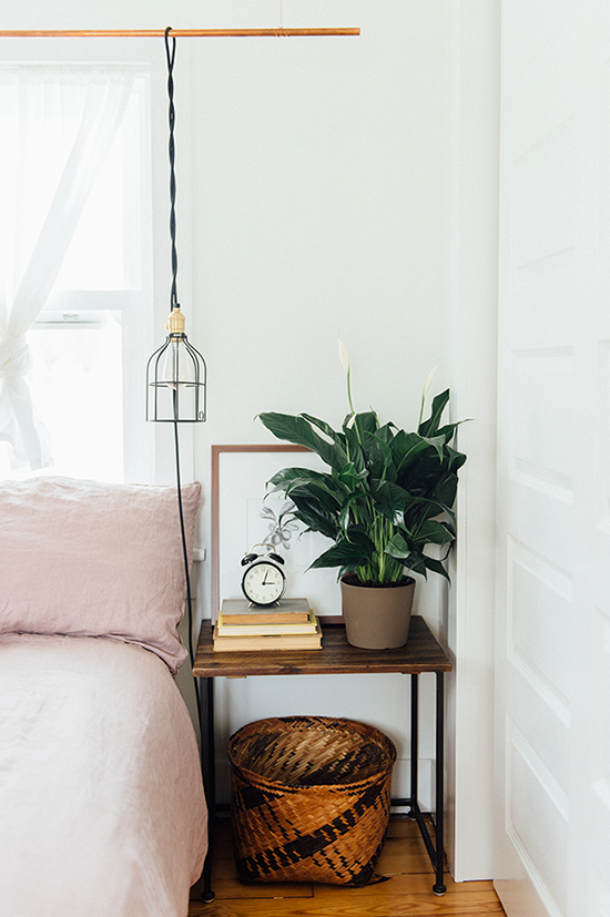 Or hang your bedside lamp so that you get good lighting without crowding your nightstand.