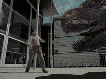 a man spins and kicks a dinosaur in the face