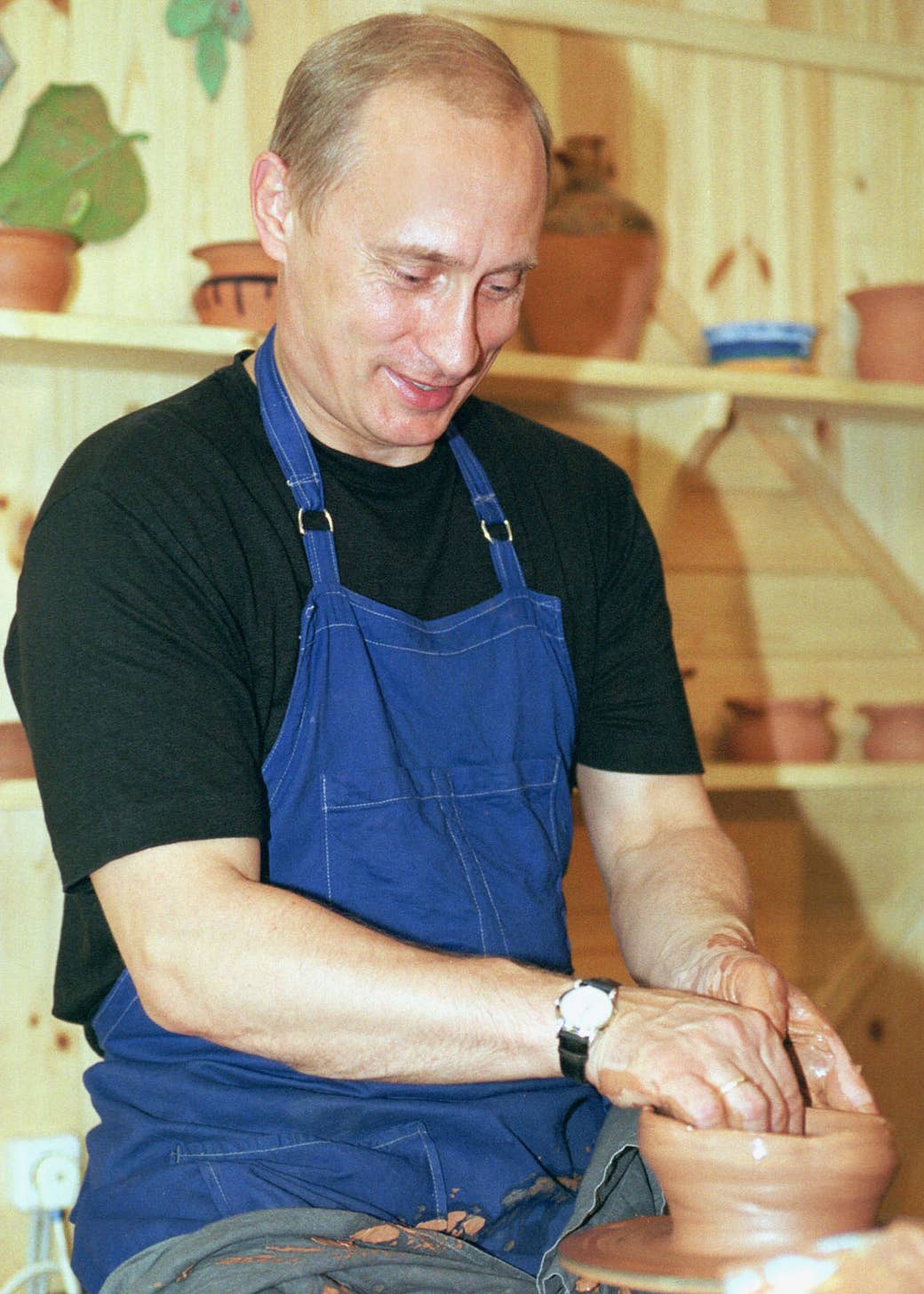 Putin tries his hand at pottery while visiting the ethnographic village of Verkhniye Mondrogi in Karelia, Russia, on Aug. 21 2001.