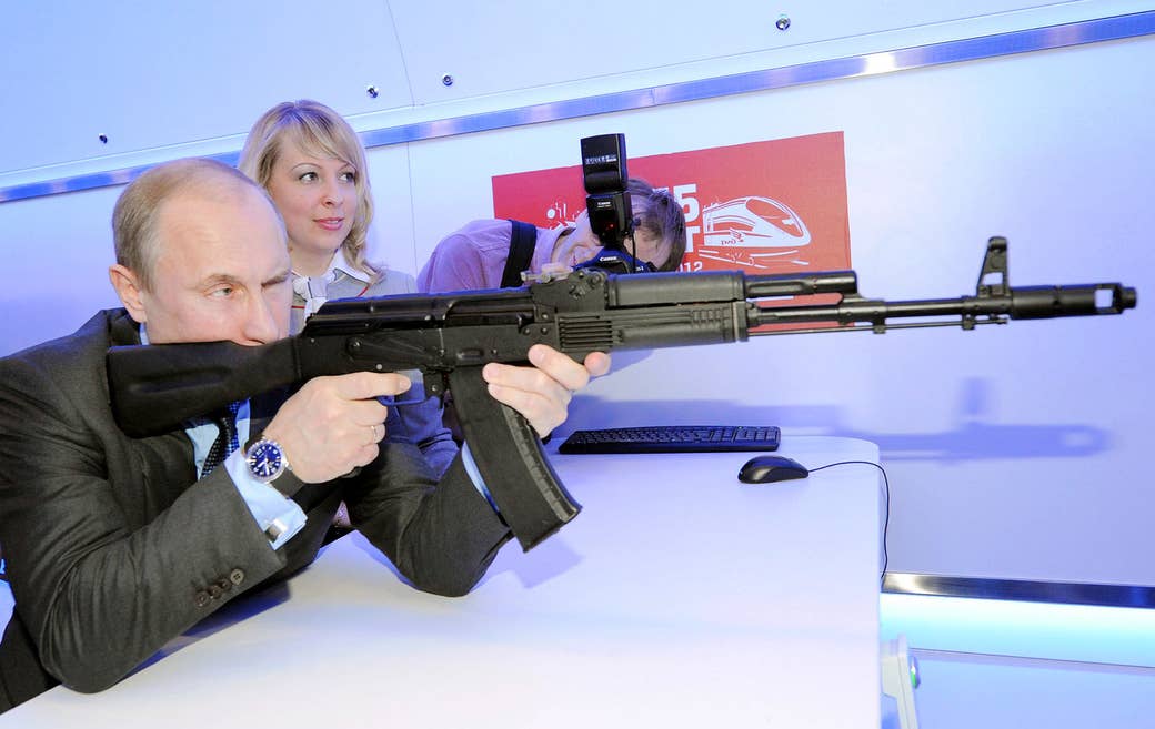 Putin takes aim with a replica of a Kalashnikov assault rifle in Moscow on April 26, 2012.