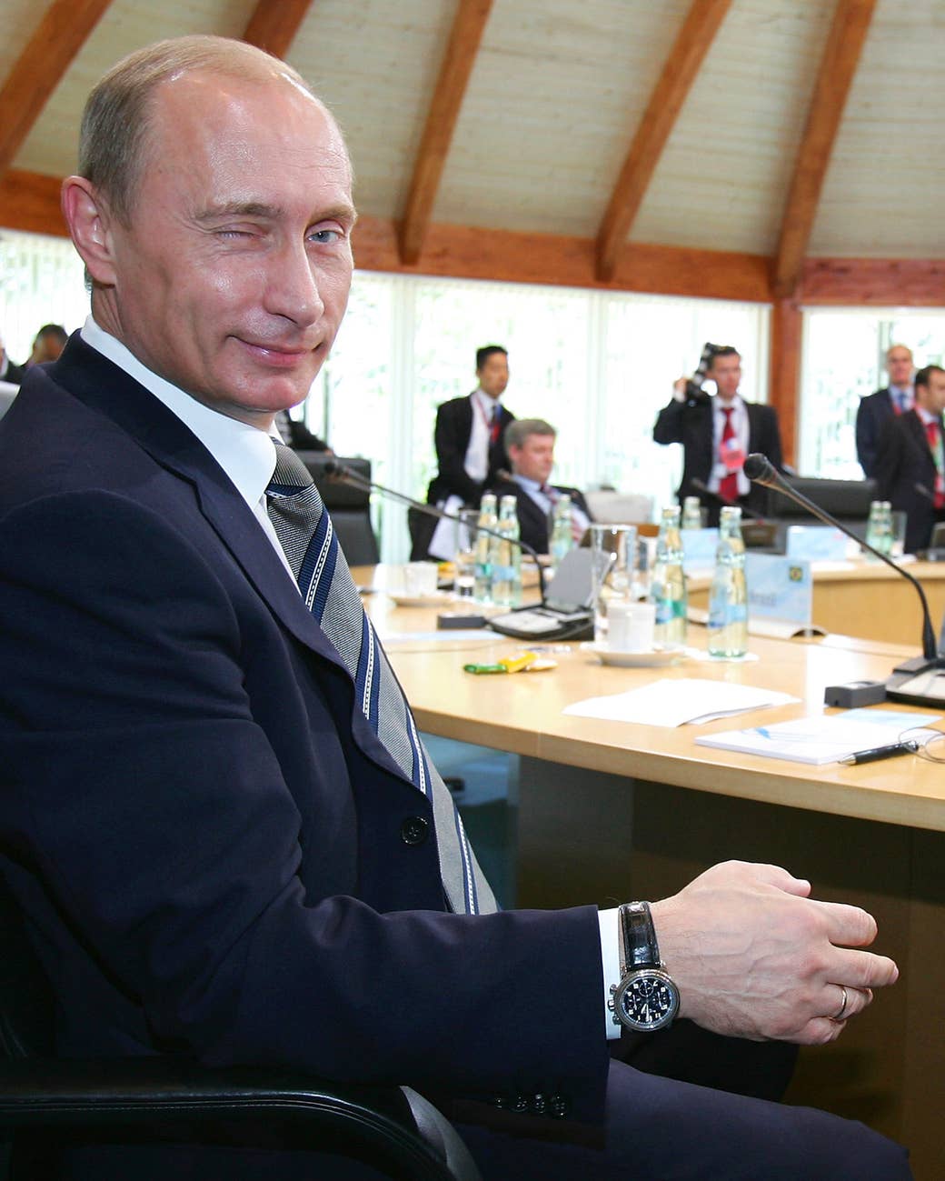Putin winks to the camera prior to a working session with leaders of the G8 countries and five developing nations on June 8, 2007, in Heiligendamm, Germany.