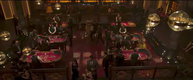The scene is set in a fancy casino, a dimly lit establishment with people playing pool and blackjack. T