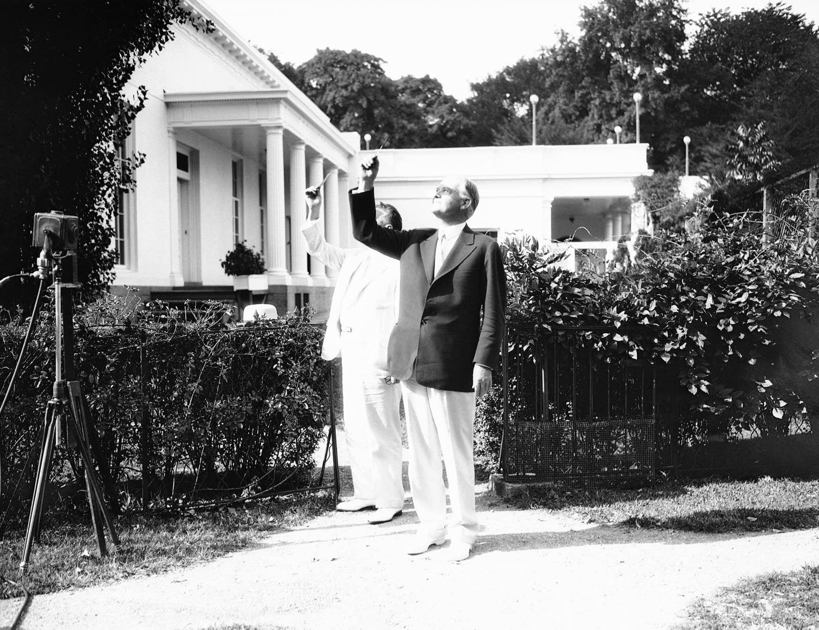 President Herbert Hoover looks at the solar eclipse from the lawn near his office on Aug. 31, 1932.