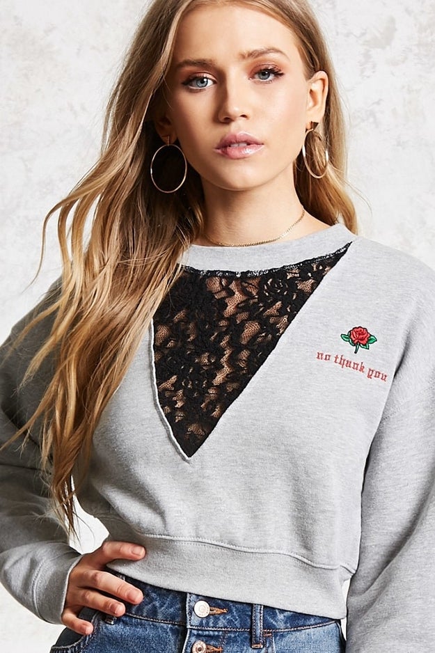 Get cozy in this cropped sweatshirt, featuring lace detailing.