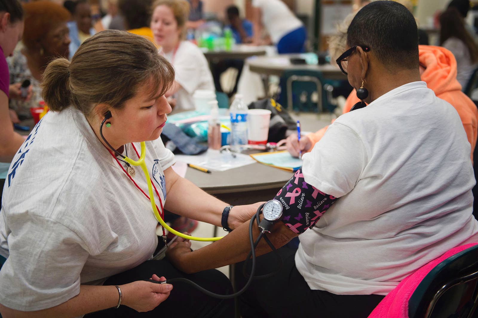 A nurse checks the blood pressure of a patient at Greensville County High School on June 25.