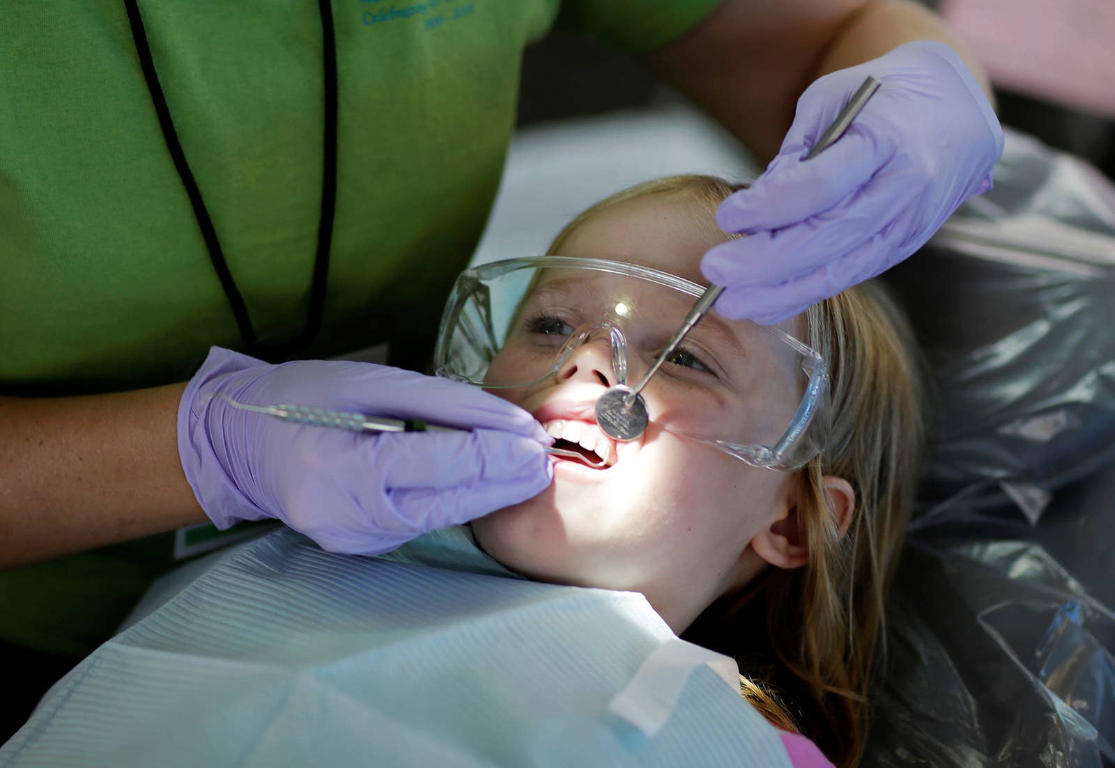 Six-year-old Mallory Collin of Abington, Virginia, has her teeth cleaned at the RAM clinic in Wise on July 22.