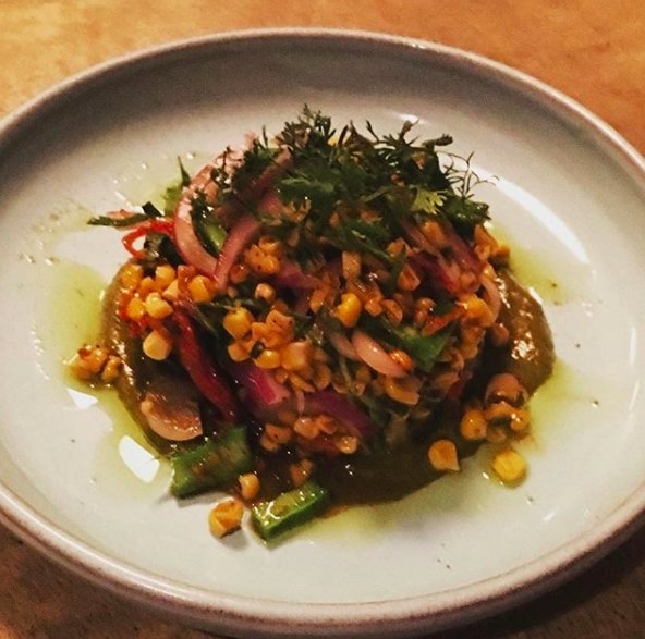 The perfect dish for the summer, the Corn Salad is made with fresh corn in spicy tomatillo salsa verde with a kick. The salad also includes tomatoes, onions, and asparagus - topped with cilantro.
