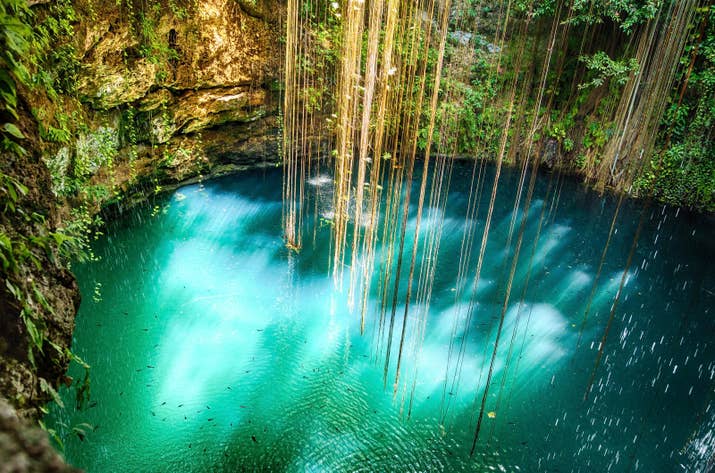 There are tons of cenotes (natural swimming holes) around Mexico's Yucatán Penninsula, but there are none quite like Ik Kil, located just near the archeological ruins of Chichen Itza. It's 85 feet deep and surrounded by rainforests, hanging vines, and lush trees.