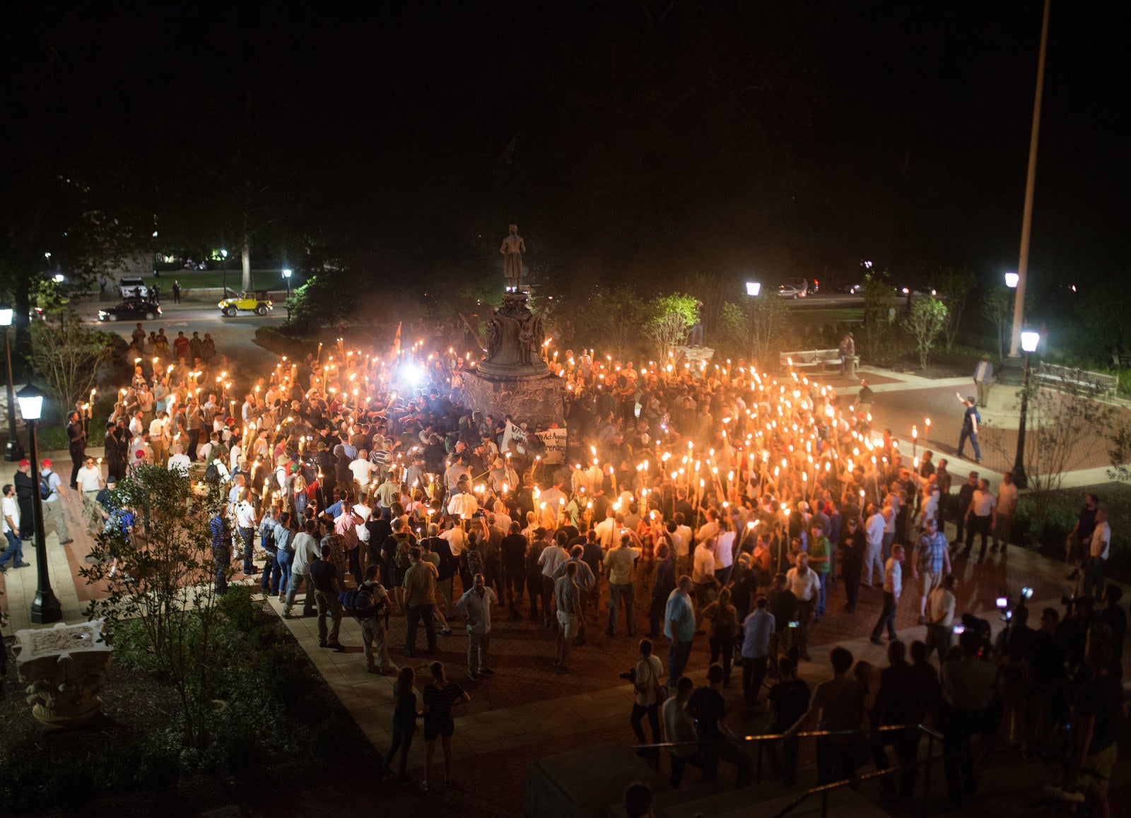 Protesters encircled counterprotesters at the base of a statue of Thomas Jefferson after marching through the University of Virginia campus on Friday night.