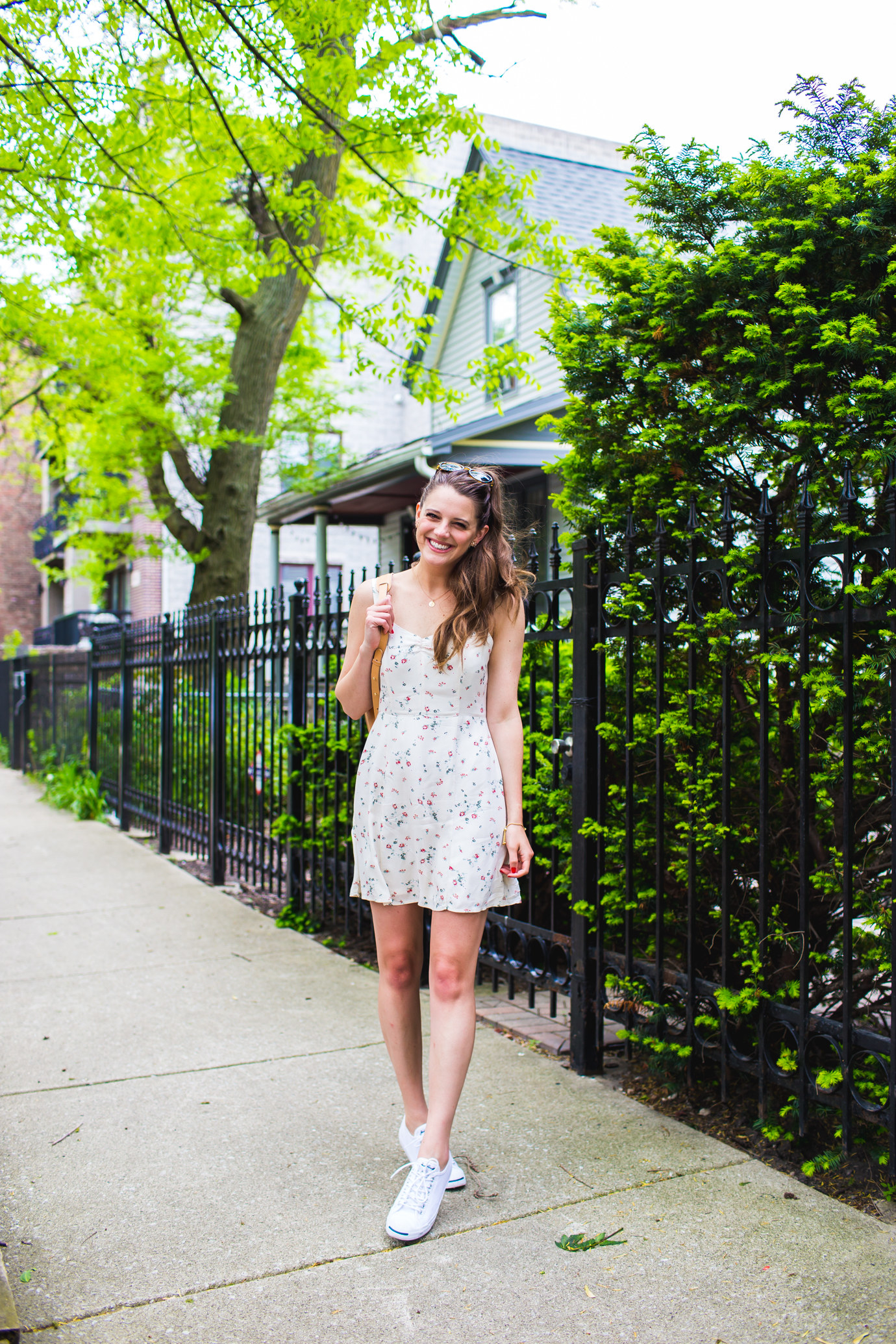 Pair a floral, feminine dress with classic low tops and you've got yourself a cute summer outfit.