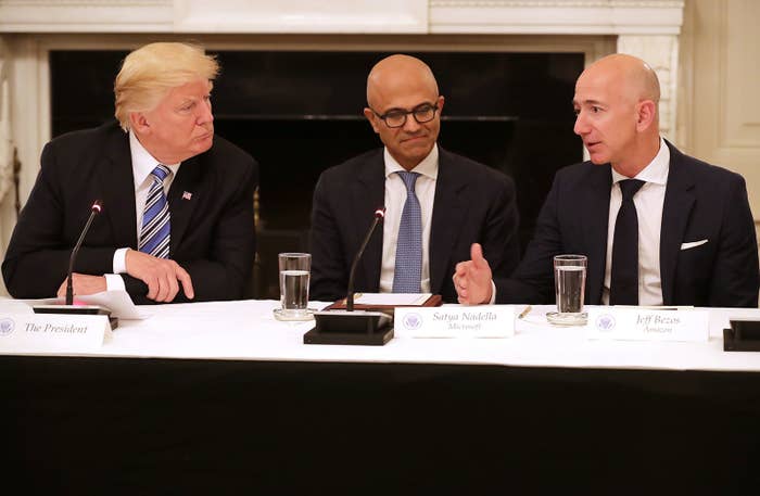 Amazon CEO Jeff Bezos speaks to President Trump at a White House meeting in June.