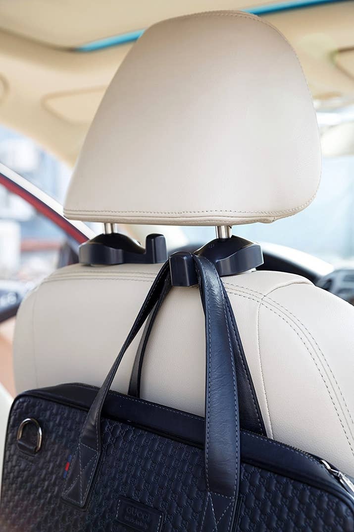 Promising review: "I recently purchased a new vehicle and was looking for some other items when I happened to stumble upon these hooks. What a great find! They are sturdy and can handle quite a bit of weight. I've used them to hang my handbag, sweater, and small bags of groceries. Everyone that has ridden in my car comments on what a great 'feature' they are, and when they discover the hooks didn't come with the vehicle, they want to know where they can get some for themselves! A great way to help keep things organized." —Amazon CustomerGet a set of two from Amazon for $7.99 (available in black and beige).