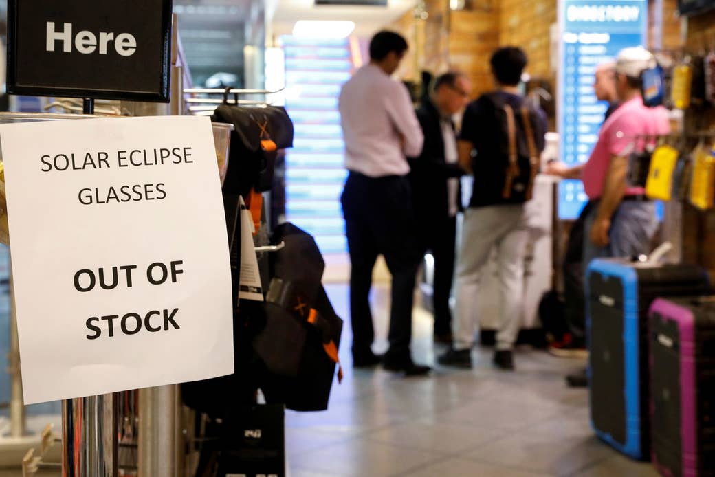 A sign telling customers that solar eclipse glasses are out of stock is displayed at a store in New York City.