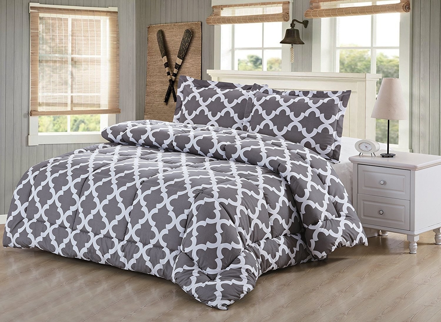 Patterned comforter on mattress in bedroom