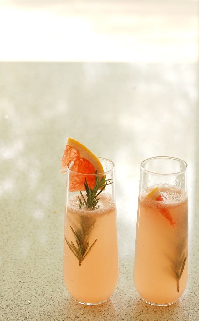 INGREDIENTS1 large Ruby Red grapefruit1 sprig fresh rosemary (plus more for garnish)1/2 cup grapefruit La Croix (pamplemousse)2 shots vodka2 splashes grapefruit bitters (optional) INSTRUCTIONS1. Halve your grapefruit and, if desired, cut off thin slivers to use later as garnish.2. Squeeze the grapefruit juice into a bowl.3. Add the rosemary leaves from one sprig of rosemary to the grapefruit juice.4. Muddle with a muddler or the back of a spoon.5. Evenly pour the fresh juice between two glasses.6. Add in 1/4 cup grapefruit La Croix and one shot of vodka to each glass.7. Garnish with grapefruit slice, rosemary, and enjoy!