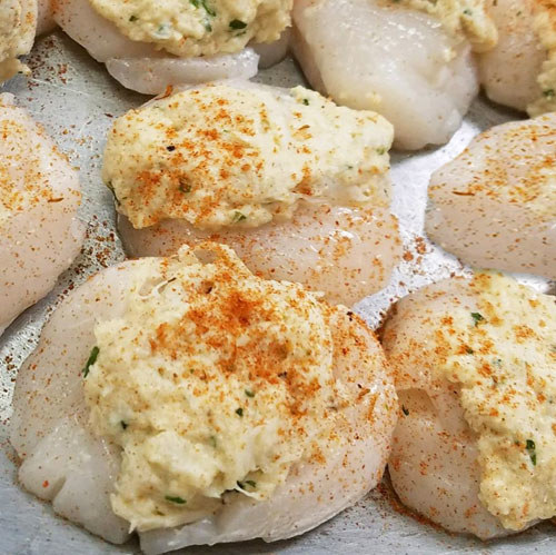 Enjoy the best of both world with this dual play between crab and scallop. The Crab Cake Stuffed Sea Scallops features tender and mild sea scallops stuffed with Cameron's signature crab cake stuffing and garnished with a sprinkling of our classic seafood seasoning.