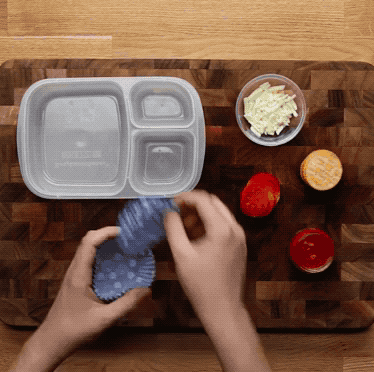 DIY PIZZA LUNCHABLESServes 1INGREDIENTS5 crackers¼ cup marinara sauce¼ cup shredded mozzarella cheese5 slices of pepperoniCupcake liners (to separate the ingredients)Grapes (optional)Crackers (optional)Place marinara in small container (we reused an old baby food jar) and place in lunchbox. Place crackers, mozzarella cheese, and pepperoni in cupcake liners next to it. Serve with grapes and crackers.