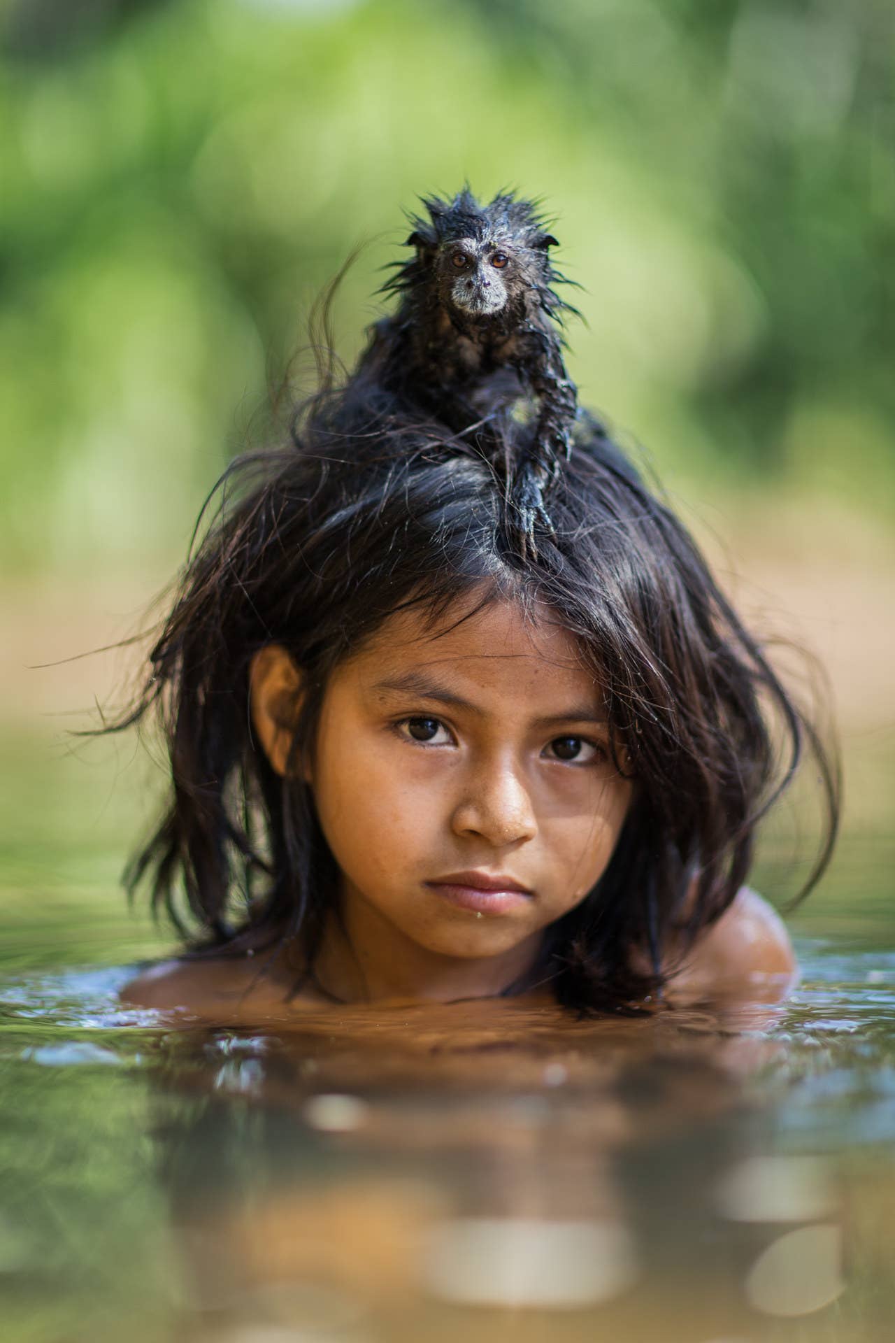 Yoina, 9, with her pet saddle-backed tamarin in Yomibato, a remote area of Peru’s Manú National Park. Yoina is a member of the Machiguenga, an indigenous hunter-gatherer community of around 1,000 people who live in the area.