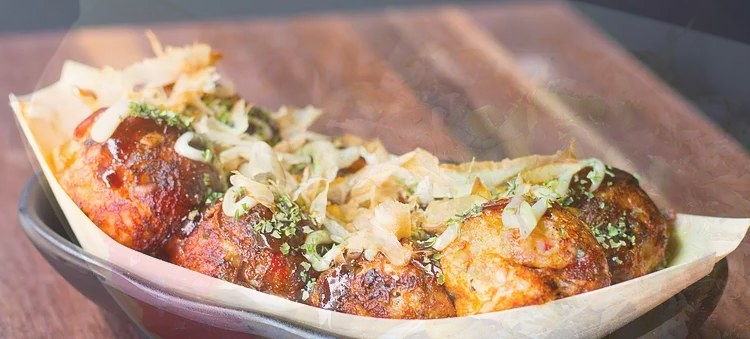 A fan favorite, the Takoyaki - or balls stuffed with octopus - has perfectly crispy exterior with soft, doughy interior. The Takoyaki at DokoDemo is made with octopus, cabbage, carrots, and flour batter and topped with bonito flakes, kewpie mayo, and sweet brown drizzle. You can either order 4 or 8 balls of takoyaki.