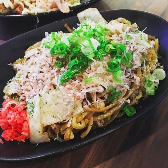 The pan-fried Yakisoba - which can be topped with your choice of pork, beef, octopus, or shrimp with either the classic or soy sauce - is generously portioned. The dish includes a bed of grilled noodles with chunks of cabbage, pickled radishes, scallions, bonito flakes, and a protein of your choice.