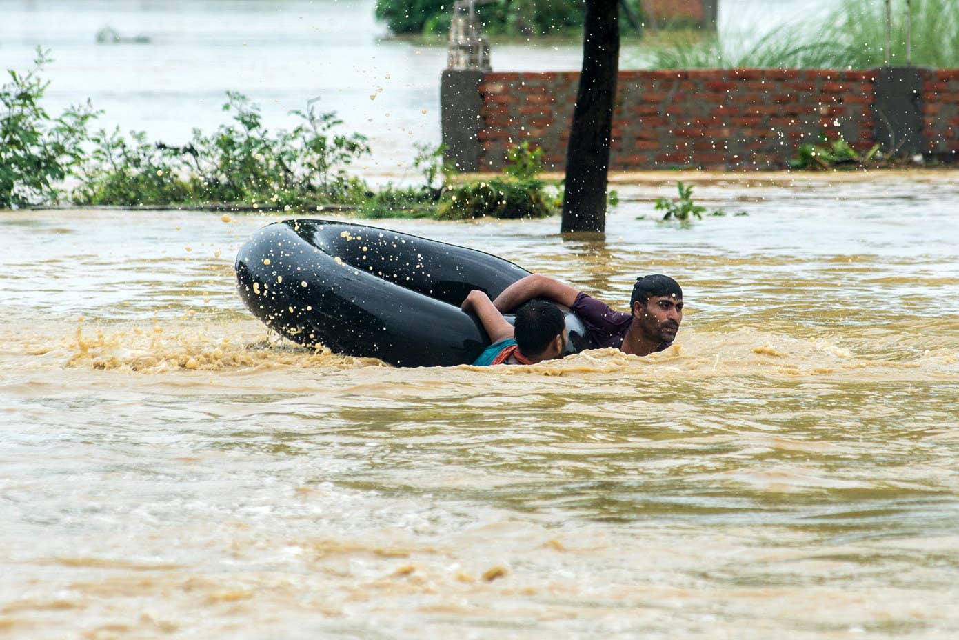 Des népalais nagent avec une bouée dans une zone inondée dans le district de Parsa, dans le sud du Népal.