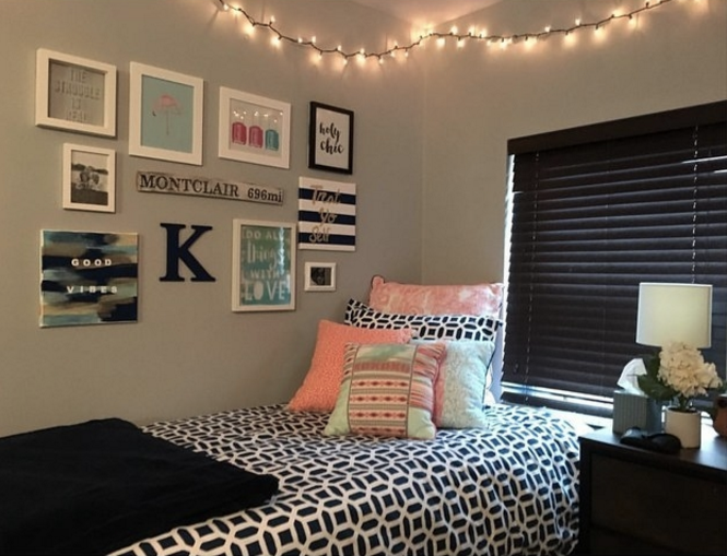 A gallery between a twin bed and fairy lights, including &quot;Good Vibes&quot; and &quot;Holy Chic&quot; framed posters