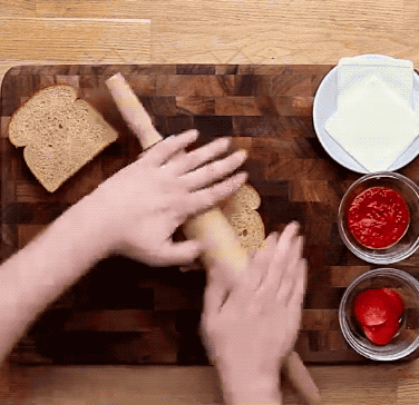 First, flatten two pieces of sandwich bread using a rolling pin: