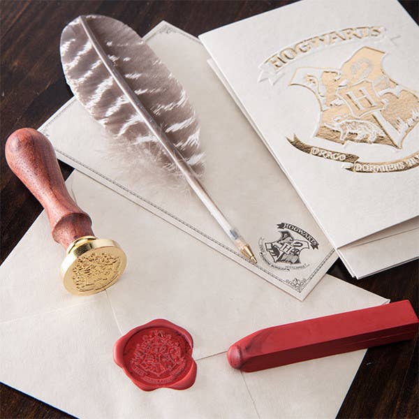 It comes with six embossed notecards, six envelopes with the Hogwarts crest, one red stick of wax, one wax seal stamp of the Hogwarts crest, and one feather "quill" (okay, it's a ballpoint pen).Get it at ThinkGeek for $11.99.
