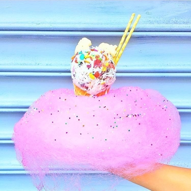 The beautiful treat from Wu Kong is two of your favorite childhood treats - cotton candy and ice cream - merged into one dreamy concoction. Choose from mouthwatering ice cream flavors like mint, cookie dough, and strawberry with your choice of topping, like Pocky sticks, animal crackers, and Fruity Pebbles. The waffle cone will be surrounded by colorful, cloud-like cotton candy with sparkles.