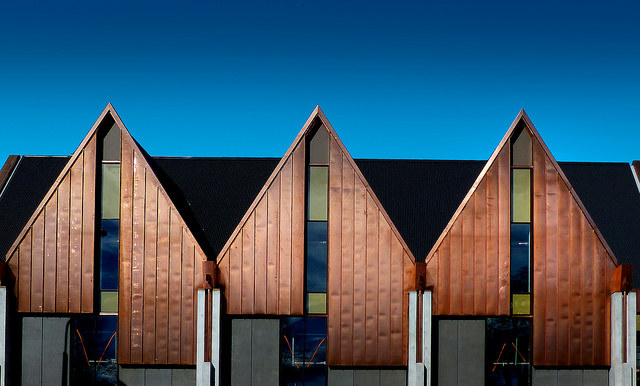 You can use cladding to emphasize the different shapes of the building. The cladding going vertical here draws your eye to the point of the triangle, creating an interesting shape.