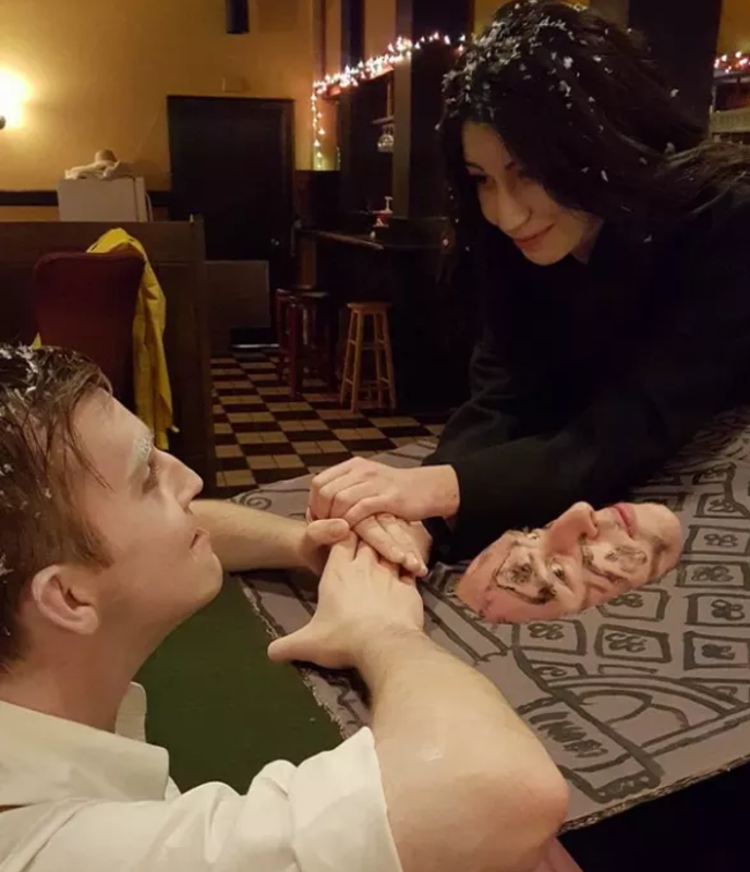 Two people dressed as Jack and Rose, and another dressed as the floating dresser