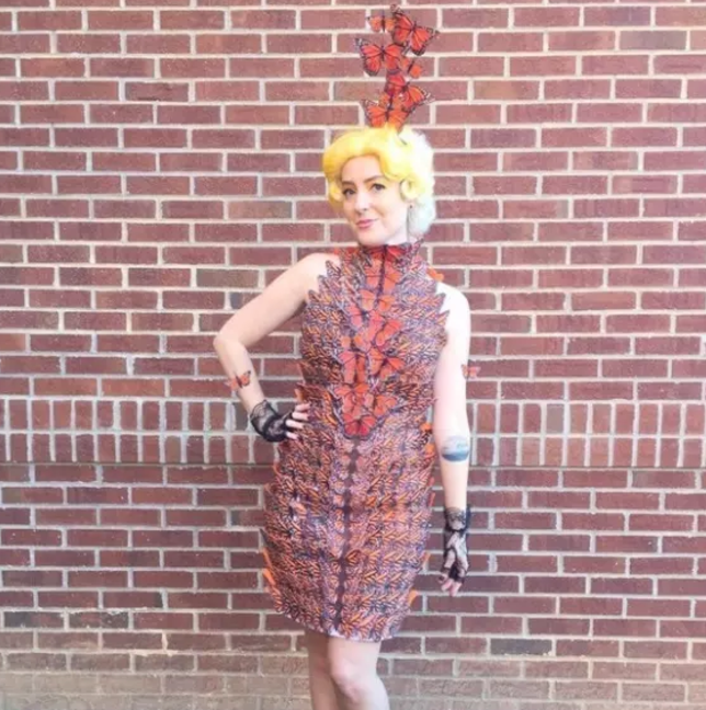 Someone dressed as Effie in a brown and red dress