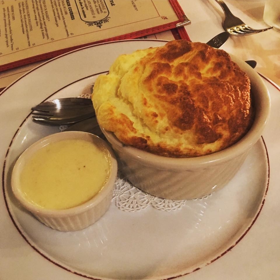 The Cheese Souffle from Bistro Chat Noir is an absolute must. Made to order (it takes 30 minutes to prepare for the dish), the perfectly cooked souffle - with crusty exterior and light, airy interior - is made with goat cheese, rosemary, black truffle oil, and thyme. Make a hole in the middle and pour the rich cheese inside for that beautifully moist bite.